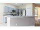 Well-lit kitchen with stainless steel appliances, grey cabinets, and granite countertops at 4579 Westgrove Way, Orlando, FL 32808
