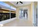A screened lanai offers a serene view of the kitchen area and green exterior at 4579 Westgrove Way, Orlando, FL 32808