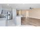 Open concept kitchen and living room with stainless steel appliances and hardwood flooring at 4579 Westgrove Way, Orlando, FL 32808