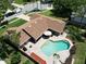 Aerial view of the property with a pool, patio, and manicured lawn at 4833 Palm Tree Ct, Windermere, FL 34786