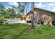 Backyard with a pool, lush lawn, and exterior home view at 4833 Palm Tree Ct, Windermere, FL 34786