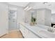 Bathroom with double sinks, shower, and neutral color palette at 4833 Palm Tree Ct, Windermere, FL 34786