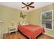 Cozy bedroom features a ceiling fan and sunny window views at 4833 Palm Tree Ct, Windermere, FL 34786