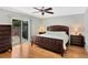 Cozy bedroom featuring a wooden bed frame, ceiling fan, and sliding glass door to the outside at 4833 Palm Tree Ct, Windermere, FL 34786