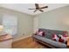Bedroom featuring a futon, a desk by a window, and light green walls at 4833 Palm Tree Ct, Windermere, FL 34786