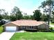 Aerial view of a tan single-story home with well maintained lawn and landscaping at 4833 Palm Tree Ct, Windermere, FL 34786
