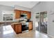 Well-equipped kitchen with stainless steel appliances, granite countertops, and outdoor access at 4833 Palm Tree Ct, Windermere, FL 34786