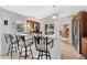 Open-concept kitchen with breakfast bar, stainless steel appliances, and seamless transition to dining area at 4833 Palm Tree Ct, Windermere, FL 34786
