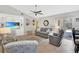 Cozy living room with built-in shelving, a ceiling fan, and access to the outdoor patio at 4833 Palm Tree Ct, Windermere, FL 34786