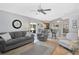 Relaxing living room with a ceiling fan, comfortable seating, and seamless connection to the kitchen at 4833 Palm Tree Ct, Windermere, FL 34786