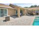 Paver patio with outdoor dining and seating next to the pool at 4833 Palm Tree Ct, Windermere, FL 34786