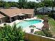 Aerial view of a backyard oasis with a sparkling pool and patio at 4833 Palm Tree Ct, Windermere, FL 34786