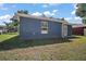 A spacious backyard with lush grass, back door access, and a modern exterior at 510 Fahnstock St, Eustis, FL 32726