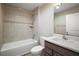 Bathroom featuring a tub and shower combo, tiled walls, and a modern vanity at 510 Fahnstock St, Eustis, FL 32726