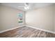 Bedroom with wood floors, neutral walls, a ceiling fan, and a window at 510 Fahnstock St, Eustis, FL 32726
