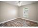 Bedroom with wood floors, ceiling fan, and window letting in lots of natural light at 510 Fahnstock St, Eustis, FL 32726