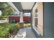 Covered entryway featuring a traditional front door, column, and window with shutters at 510 Fahnstock St, Eustis, FL 32726
