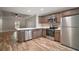 Modern kitchen with stainless steel appliances, wood cabinets, and light countertops at 510 Fahnstock St, Eustis, FL 32726