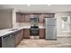 Modern kitchen featuring new stainless steel appliances, white countertops, and wood cabinets at 510 Fahnstock St, Eustis, FL 32726
