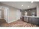 Beautiful open-concept kitchen features stainless steel appliances, stone countertops, and wood floors at 510 Fahnstock St, Eustis, FL 32726