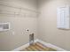 Laundry room with hookups, shelving, and a neutral wall color at 510 Fahnstock St, Eustis, FL 32726