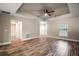Spacious living room featuring wood floors, tray ceiling, and natural light at 510 Fahnstock St, Eustis, FL 32726