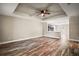 Open-concept living area featuring wood flooring and a tray ceiling with a ceiling fan at 510 Fahnstock St, Eustis, FL 32726
