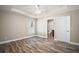 Main bedroom with tray ceiling, wood floors, and en suite bathroom at 510 Fahnstock St, Eustis, FL 32726