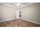 Spacious main bedroom with ceiling fan, wood floors, and interior entranceway at 510 Fahnstock St, Eustis, FL 32726