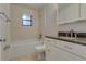 Bathroom with white tiling, vanity, toilet, and tub shower combination at 5518 Cretan Way, Winter Park, FL 32792