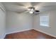 Cozy bedroom with stylish ceiling fan, and wood look floors at 5518 Cretan Way, Winter Park, FL 32792