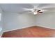 Bright bedroom with wood floors, ceiling fan, white walls, and ample natural light at 5518 Cretan Way, Winter Park, FL 32792