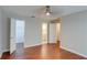 This bedroom features wood-look flooring and multiple doorways to other rooms at 5518 Cretan Way, Winter Park, FL 32792