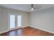 A bright room features wood-look flooring and sliding doors to the exterior at 5518 Cretan Way, Winter Park, FL 32792