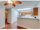 Bright kitchen with stainless steel appliances, light oak cabinets, and tile backsplash at 5518 Cretan Way, Winter Park, FL 32792