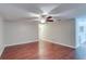 Spacious living room featuring beautiful wood-look floors and a ceiling fan at 5518 Cretan Way, Winter Park, FL 32792