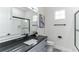 Modern bathroom featuring a sleek vanity with stone countertop and a glass-enclosed shower at 5531 Dallas Blvd, Orlando, FL 32833