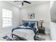 Comfortable bedroom featuring a cozy bed with blue accents, stylish lamps, and soft rug at 5531 Dallas Blvd, Orlando, FL 32833