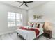 Comfortable bedroom features a ceiling fan, a large window and a decorative headboard at 5531 Dallas Blvd, Orlando, FL 32833