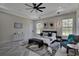 Main bedroom features a tray ceiling, ceiling fan, decorative art and large windows at 5531 Dallas Blvd, Orlando, FL 32833