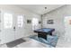 Foyer features a pool table, eye-catching light fixture, wood-look tile floors and textured accent wall at 5531 Dallas Blvd, Orlando, FL 32833