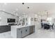 Open-concept kitchen with a large island, stainless steel appliances, and a view of the living and dining areas at 5531 Dallas Blvd, Orlando, FL 32833