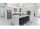 Spacious kitchen featuring a large island with seating, stainless steel appliances, and modern cabinetry at 5531 Dallas Blvd, Orlando, FL 32833