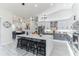 Bright kitchen boasts a large island with seating, modern light fixtures, and stainless steel appliances at 5531 Dallas Blvd, Orlando, FL 32833