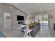 Open floor plan living room with a fireplace, modern decor, and sleek sliding doors to backyard at 5531 Dallas Blvd, Orlando, FL 32833