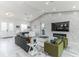 Open floor plan living room, with modern decor, featuring a vaulted ceiling and tile floors at 5531 Dallas Blvd, Orlando, FL 32833