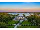 Aerial view of a luxury estate with manicured lawns and landscaping on a lakefront property at 570 Manor Rd, Maitland, FL 32751