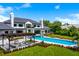Expansive backyard featuring a stunning pool, pergola, multiple seating areas, and beautifully landscaped gardens at 570 Manor Rd, Maitland, FL 32751