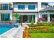 Elegant backyard featuring a pool with a waterfall feature, lush landscaping, and a modern home exterior at 570 Manor Rd, Maitland, FL 32751