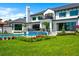 Expansive backyard featuring a sparkling pool, manicured lawn, and elegant landscaping surrounding a modern home at 570 Manor Rd, Maitland, FL 32751